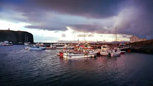 harbor-boats-in-iceland-during-sunset-with-lighthouse