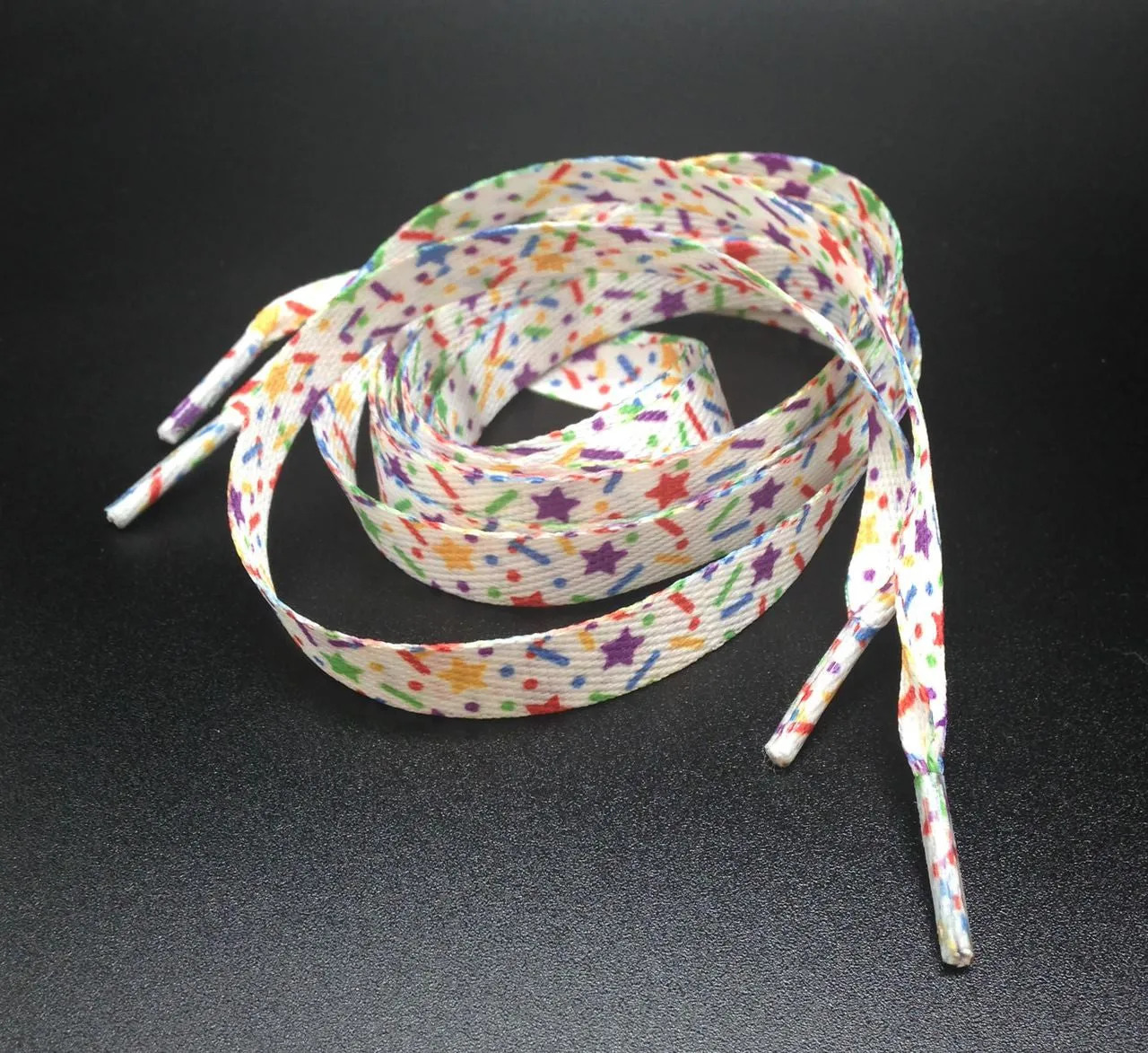 Shoelaces with sprinkles in primary colors printed on standard shoelace material 54" long